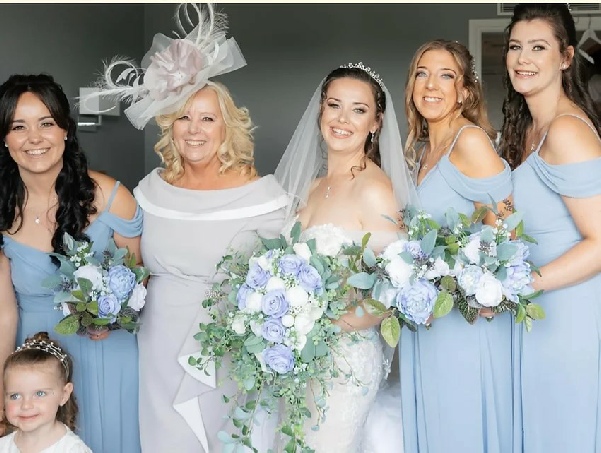 Bride with three bridesmaids in blue and brides mother